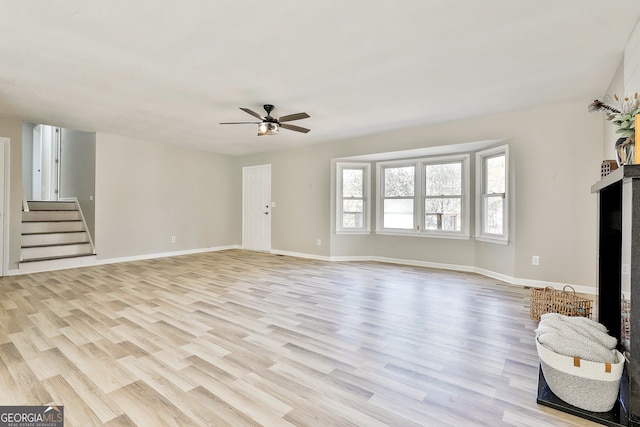 unfurnished living room with ceiling fan and light hardwood / wood-style floors