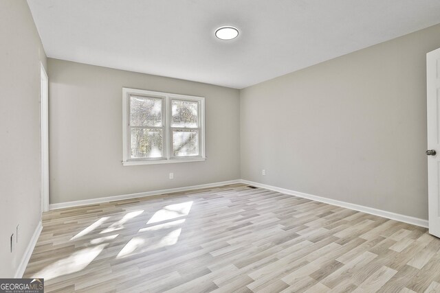 spare room with light wood-type flooring