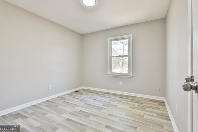 unfurnished room with light hardwood / wood-style flooring