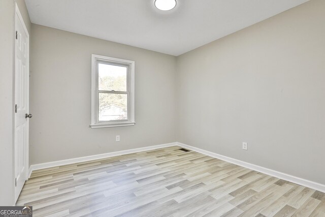 unfurnished room featuring light wood-type flooring