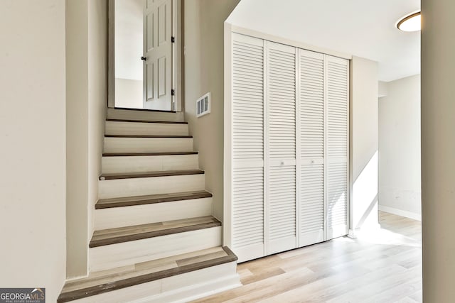 stairs with hardwood / wood-style flooring