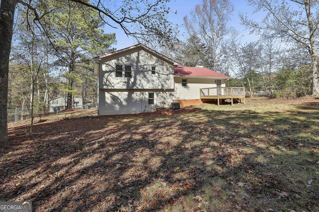 rear view of property featuring a deck