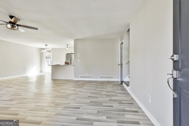 living room featuring ceiling fan and light wood-type flooring