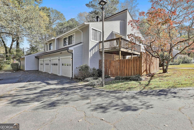 view of home's exterior featuring a garage and a wooden deck