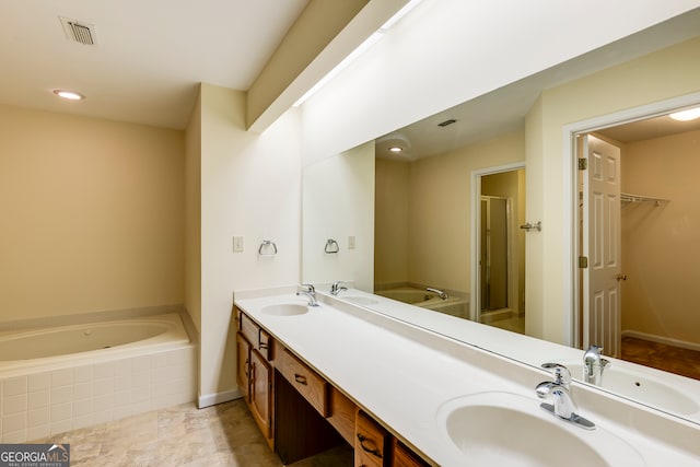 bathroom featuring tile patterned floors, vanity, and shower with separate bathtub