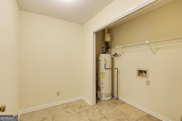 washroom featuring laundry area, baseboards, a textured ceiling, washer hookup, and water heater