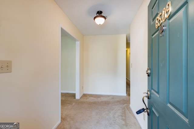 foyer with light colored carpet