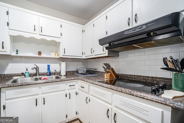 kitchen featuring white cabinets, decorative backsplash, black electric cooktop, and sink