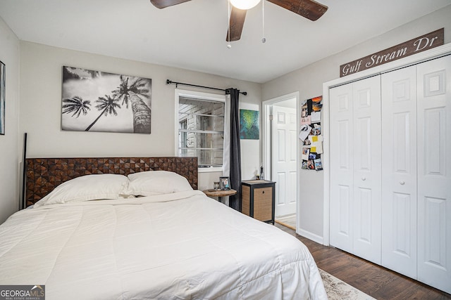 bedroom featuring ceiling fan, dark hardwood / wood-style flooring, and a closet