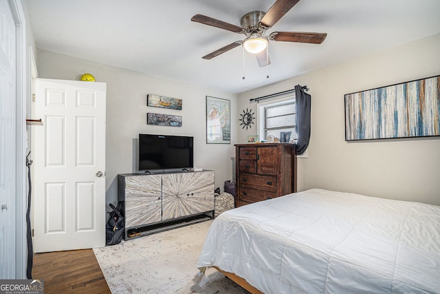 bedroom with ceiling fan and dark wood-type flooring