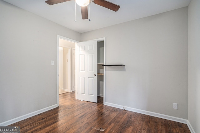 spare room with dark hardwood / wood-style floors and ceiling fan