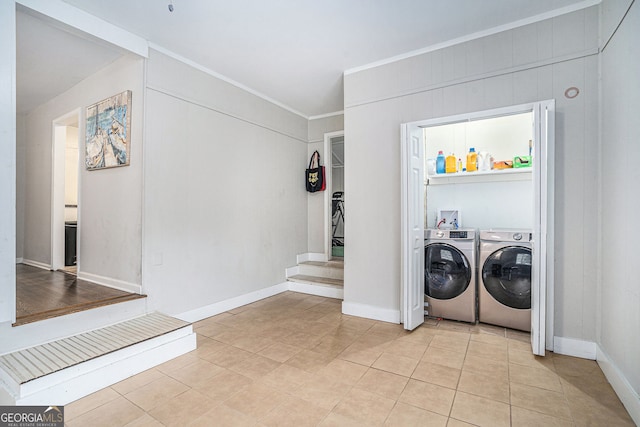 laundry room featuring light tile patterned floors and washing machine and dryer