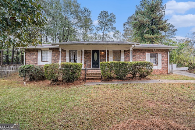 single story home featuring covered porch and a front yard