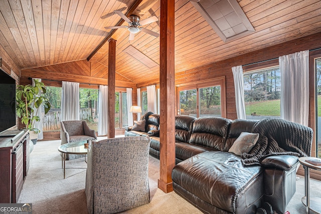 carpeted living room with ceiling fan, wood walls, wooden ceiling, and vaulted ceiling