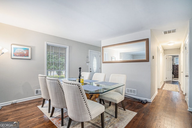 dining space with dark hardwood / wood-style floors