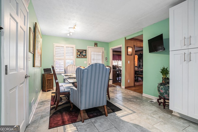 dining room featuring a textured ceiling