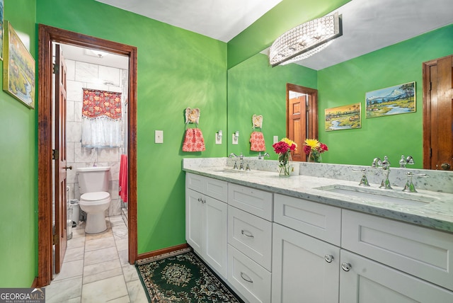 bathroom featuring tile patterned floors, vanity, and toilet