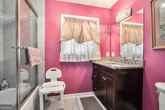 full bathroom with tile patterned floors, vanity, enclosed tub / shower combo, and toilet