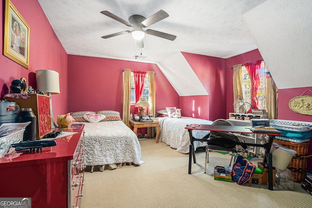 bedroom featuring lofted ceiling, ceiling fan, carpet floors, and a textured ceiling