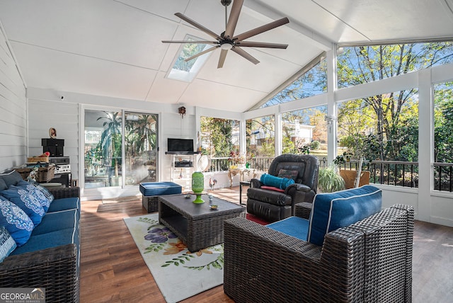 sunroom / solarium with ceiling fan, plenty of natural light, and lofted ceiling with skylight