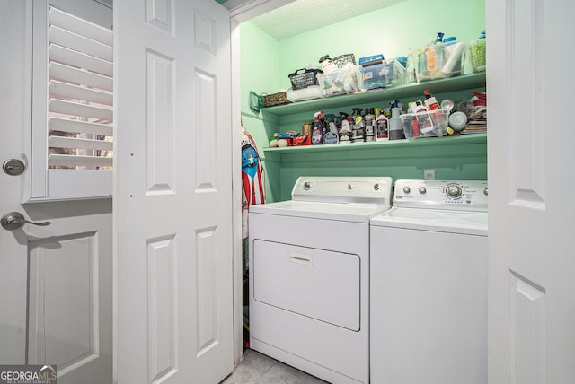 laundry room with washing machine and dryer and a textured ceiling