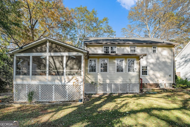 back of house with a yard and a sunroom