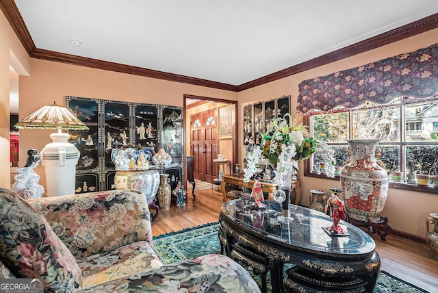 interior space with hardwood / wood-style flooring and crown molding