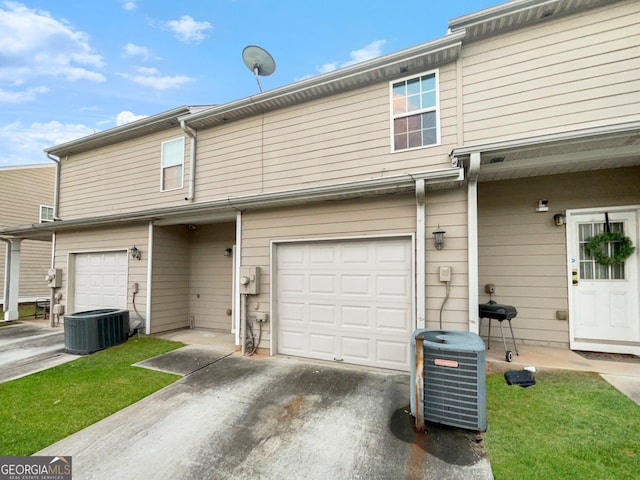 exterior space featuring a garage and central AC