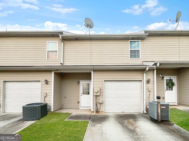 view of front of house featuring central air condition unit and a garage