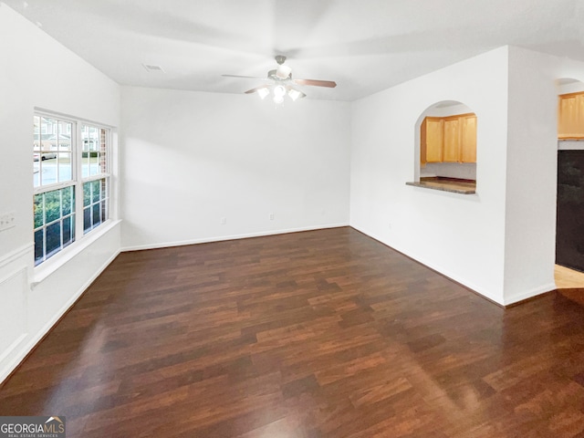 empty room featuring ceiling fan and dark hardwood / wood-style floors