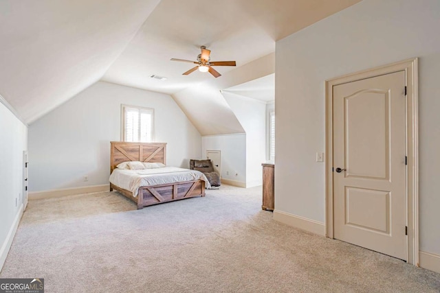 bedroom with ceiling fan, light colored carpet, and vaulted ceiling