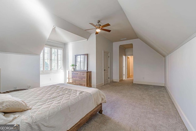 carpeted bedroom featuring ceiling fan, ornamental molding, and vaulted ceiling