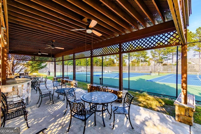 view of patio / terrace with ceiling fan and tennis court