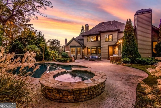 exterior space featuring a patio area and a pool with hot tub