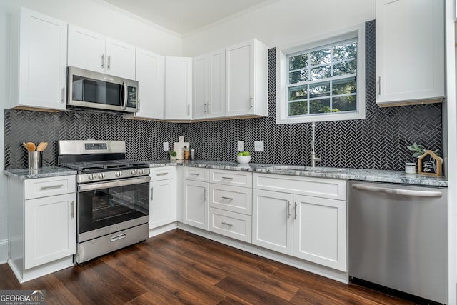 kitchen featuring appliances with stainless steel finishes, dark hardwood / wood-style floors, and white cabinetry