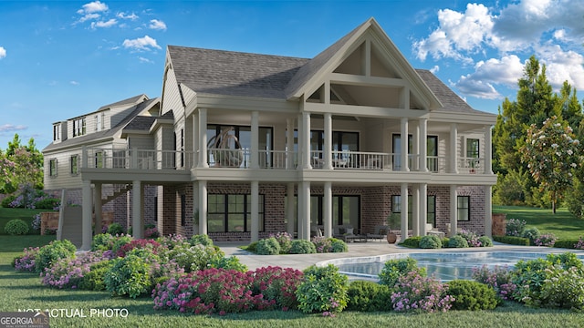 rear view of property featuring a lawn, a balcony, and a patio