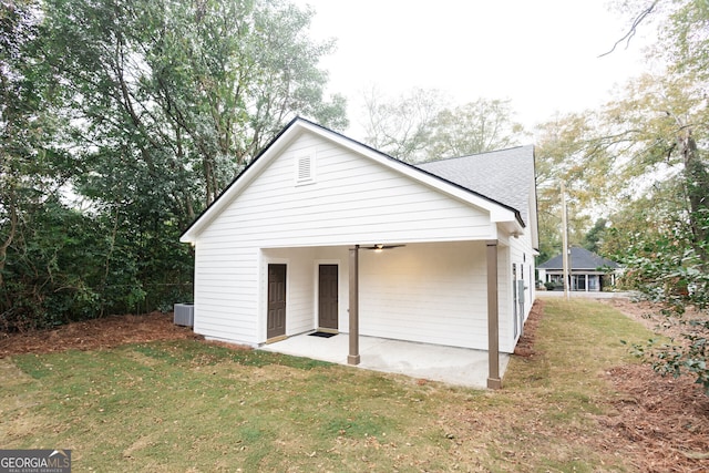 back of property with a lawn, a patio area, and ceiling fan