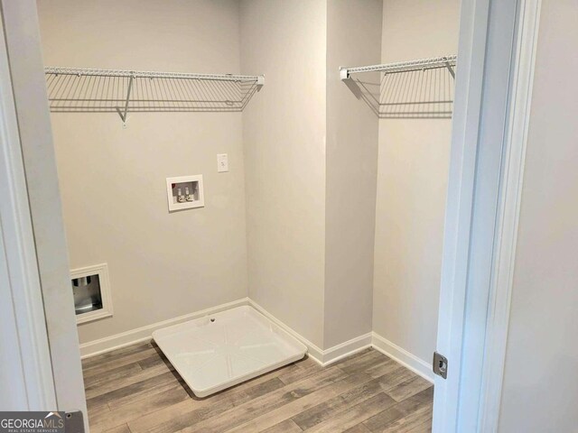 laundry room featuring washer hookup and wood-type flooring