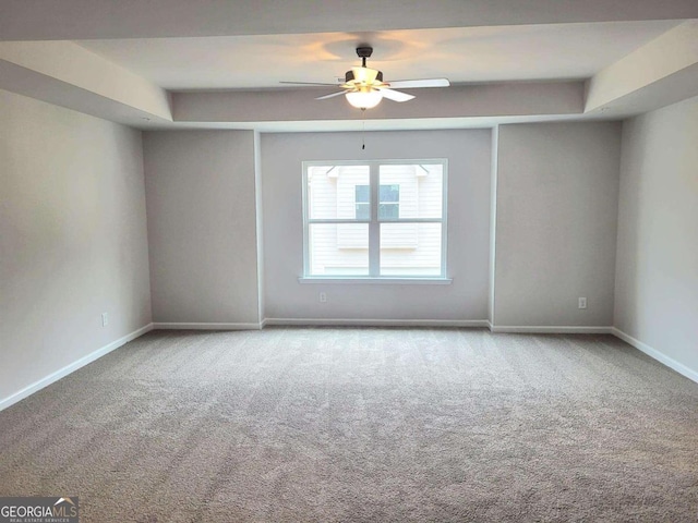 spare room featuring ceiling fan and light colored carpet