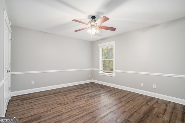 spare room with dark hardwood / wood-style floors and ceiling fan