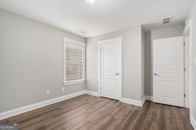 unfurnished bedroom featuring dark wood-type flooring