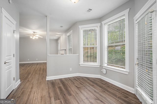 unfurnished room with dark hardwood / wood-style floors and ceiling fan