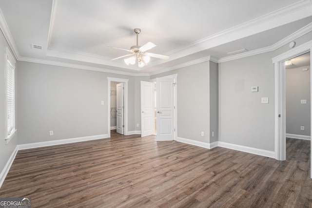 unfurnished bedroom with ceiling fan, dark hardwood / wood-style floors, a walk in closet, and crown molding