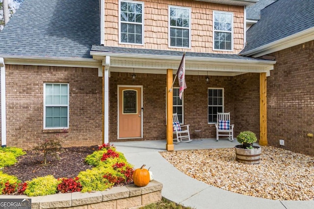 view of exterior entry featuring a porch