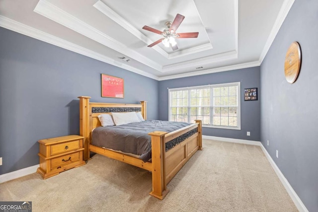 bedroom with a tray ceiling, ceiling fan, light carpet, and ornamental molding