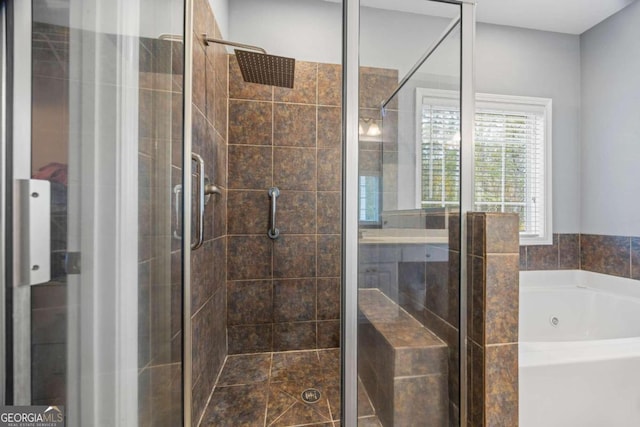 bathroom with shower with separate bathtub