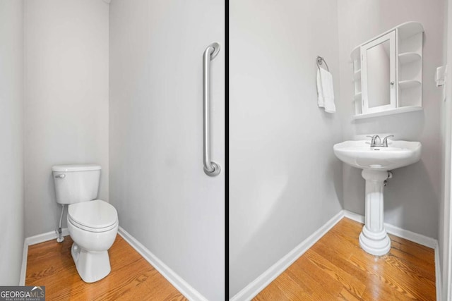 bathroom with hardwood / wood-style floors and toilet