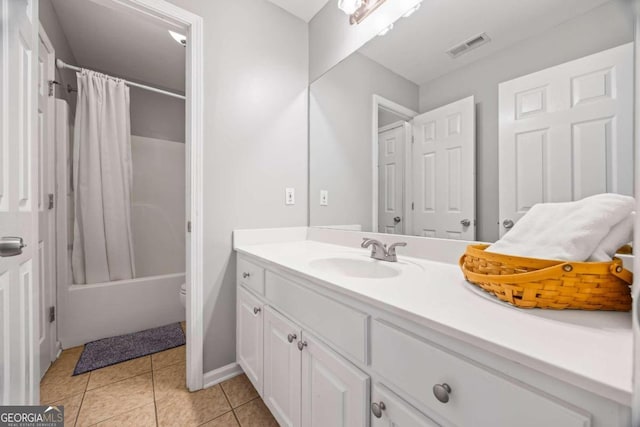 full bathroom with tile patterned flooring, vanity, toilet, and shower / bath combo with shower curtain