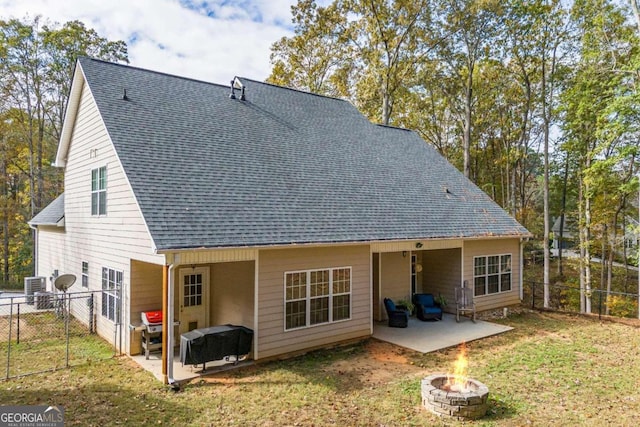 back of property with a lawn and a patio