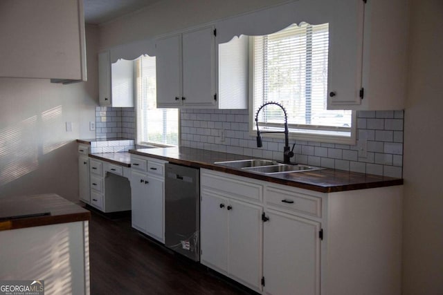 kitchen featuring white cabinets, dishwasher, sink, and a wealth of natural light